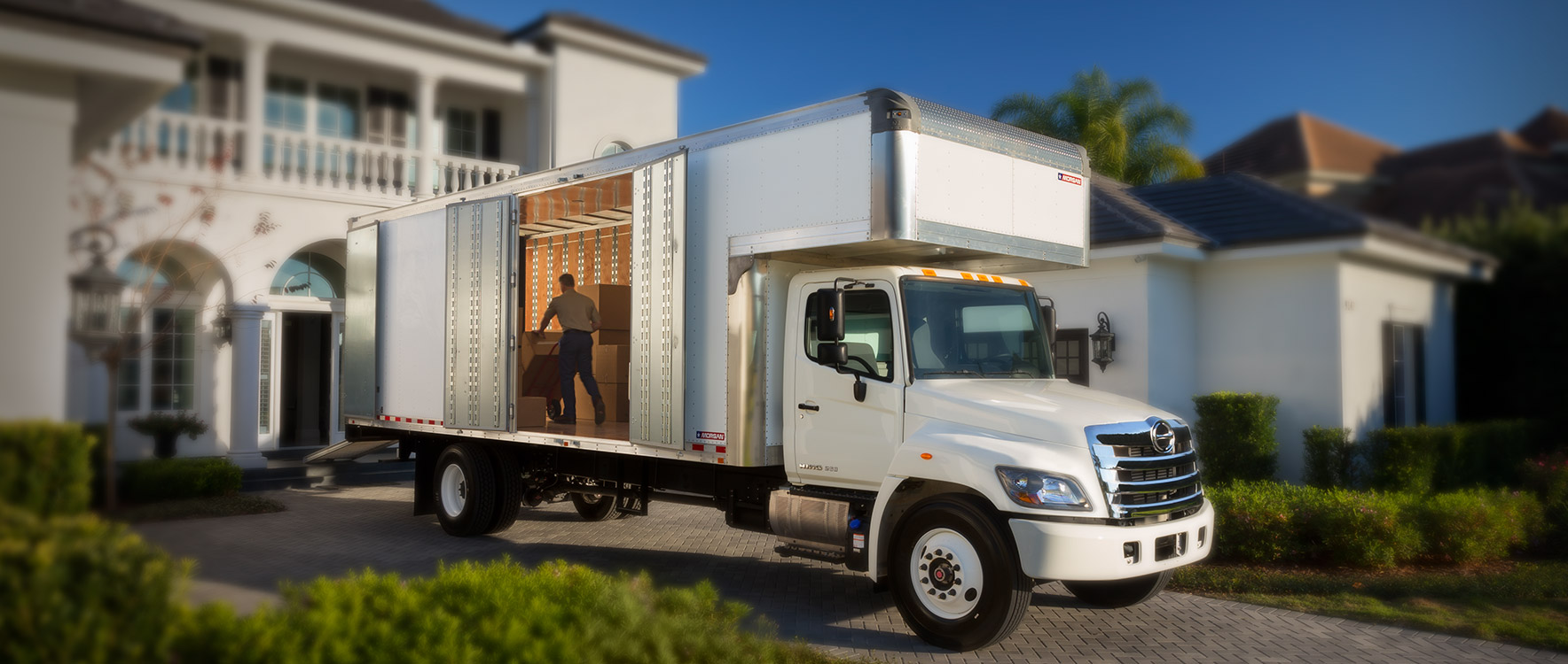 Dry Freight Furniture Mover unloading boxes at a home - Morgan moving truck bodies