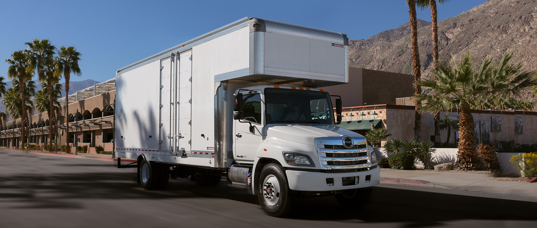 Dry Freight Furniture Mover driving thru a small town - Morgan moving truck bodies