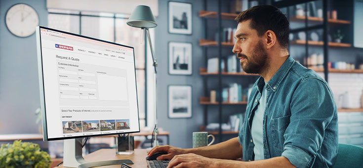 Customer fills out online information on a computer in his home environment.